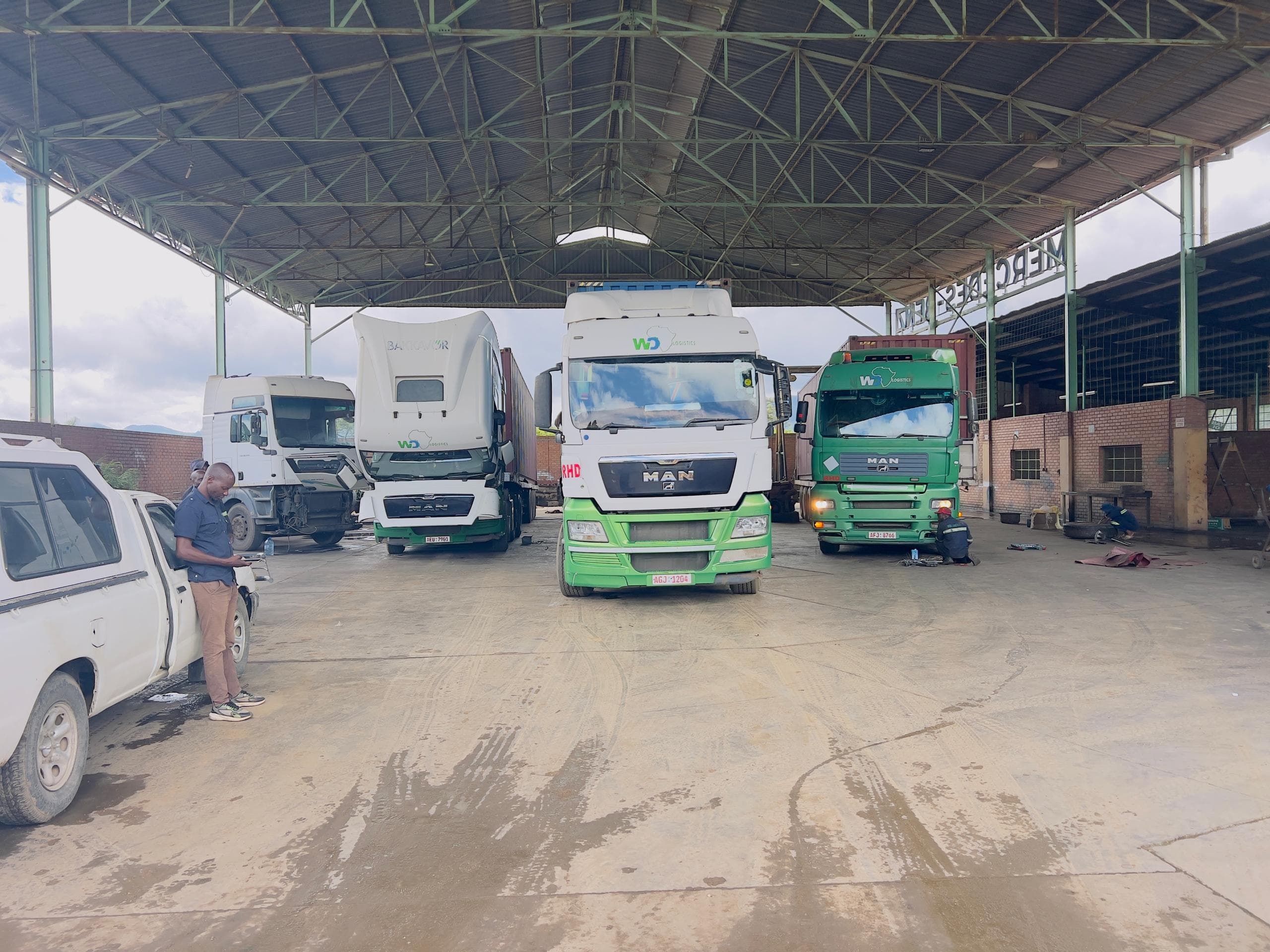 WD Logistics trucks parked under the loading shed at the Nyakamete yard, Mutare